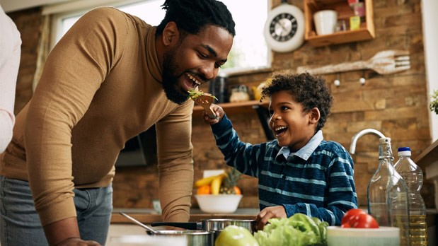 Father and son eating a salad