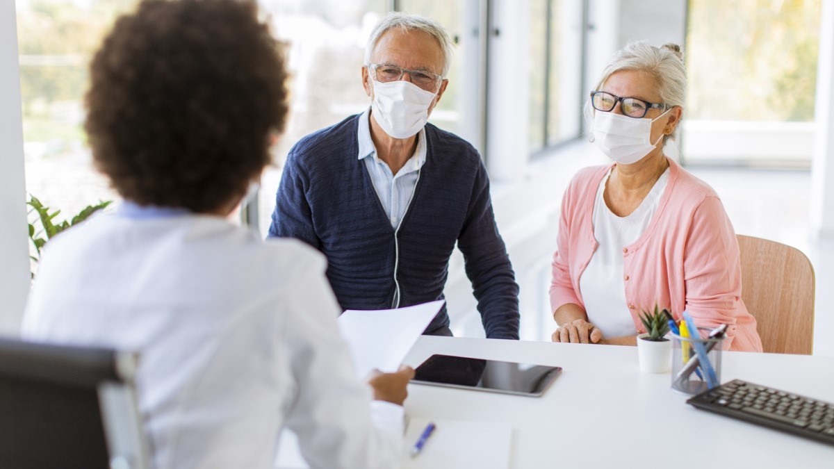 man doctor A patient and his wife talking with his doctor