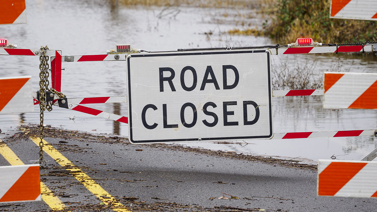 flooded road closed Road closed sign on flooded road