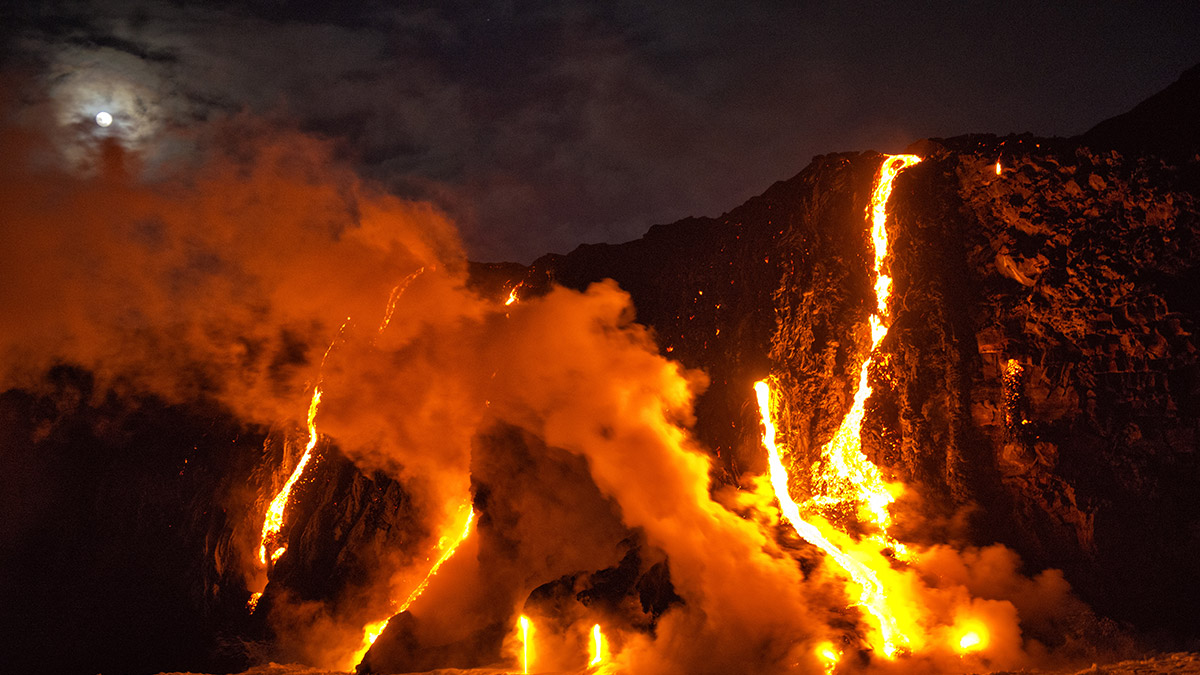 volcano erupting Red hot lava and ash spewing from an active volcano.