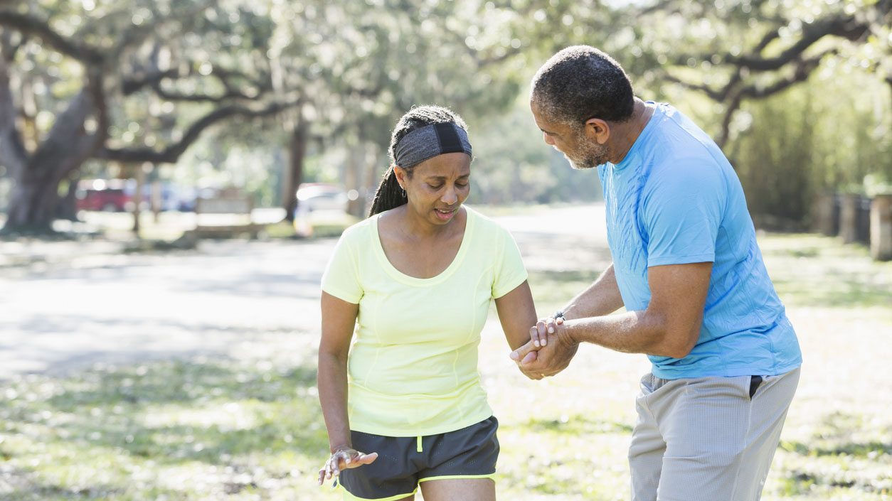 A man helping a woman walk safely on the street