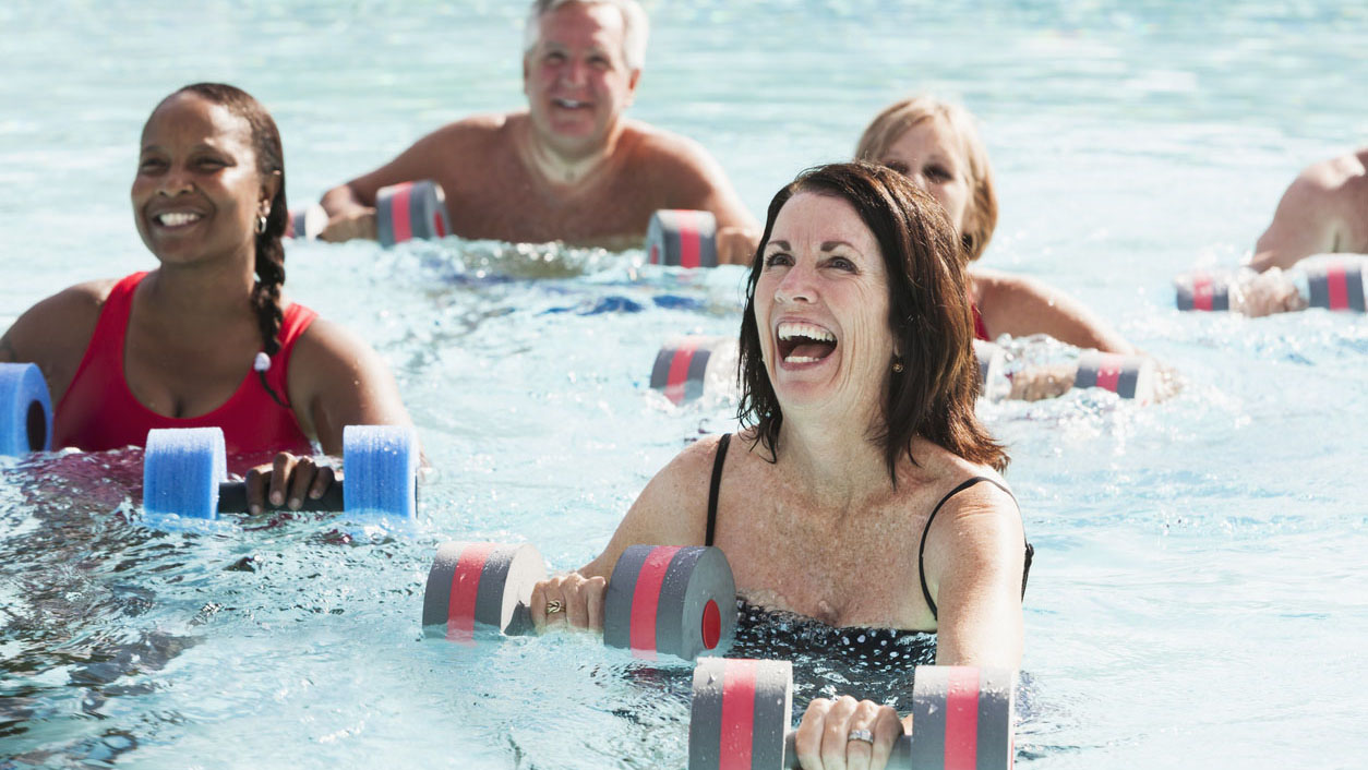 Group of adults enjoying water aerobics.